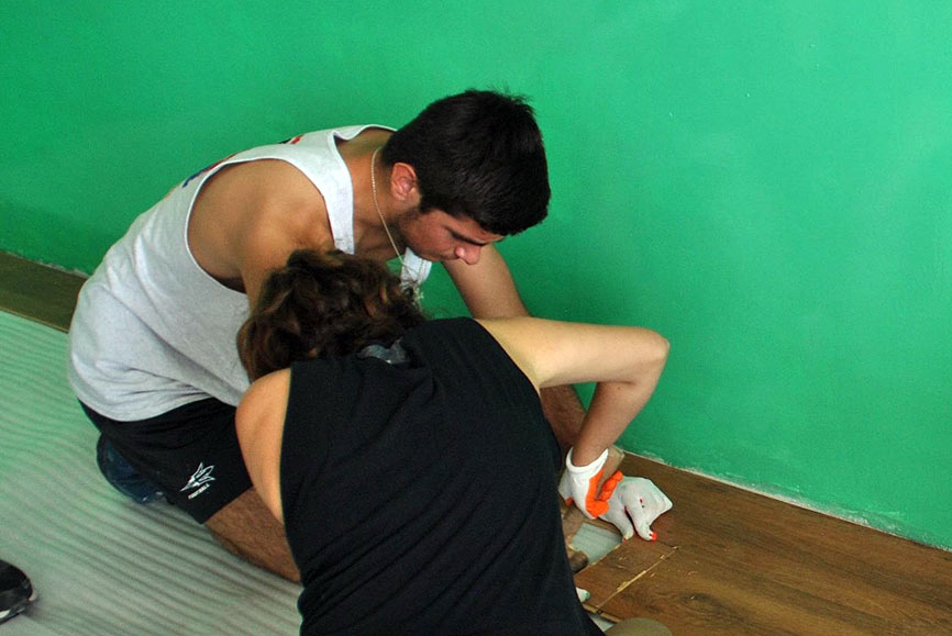SERVICE Armenia 2016 participants Alex Hachigian and Noushig Belian work to install new laminate flooring in one of the two classrooms at the Lchashen village school. Project sponsored through funds earned and donated through tutoring and other summer jobs by Alex Hachigian.